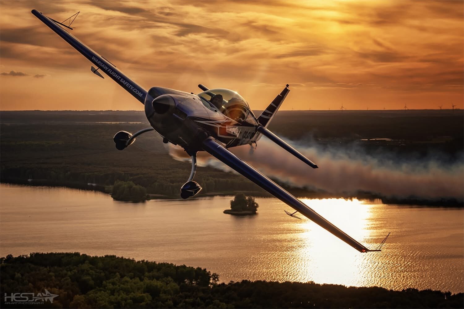 Extra 300L SP-EKS at sunset over a lake