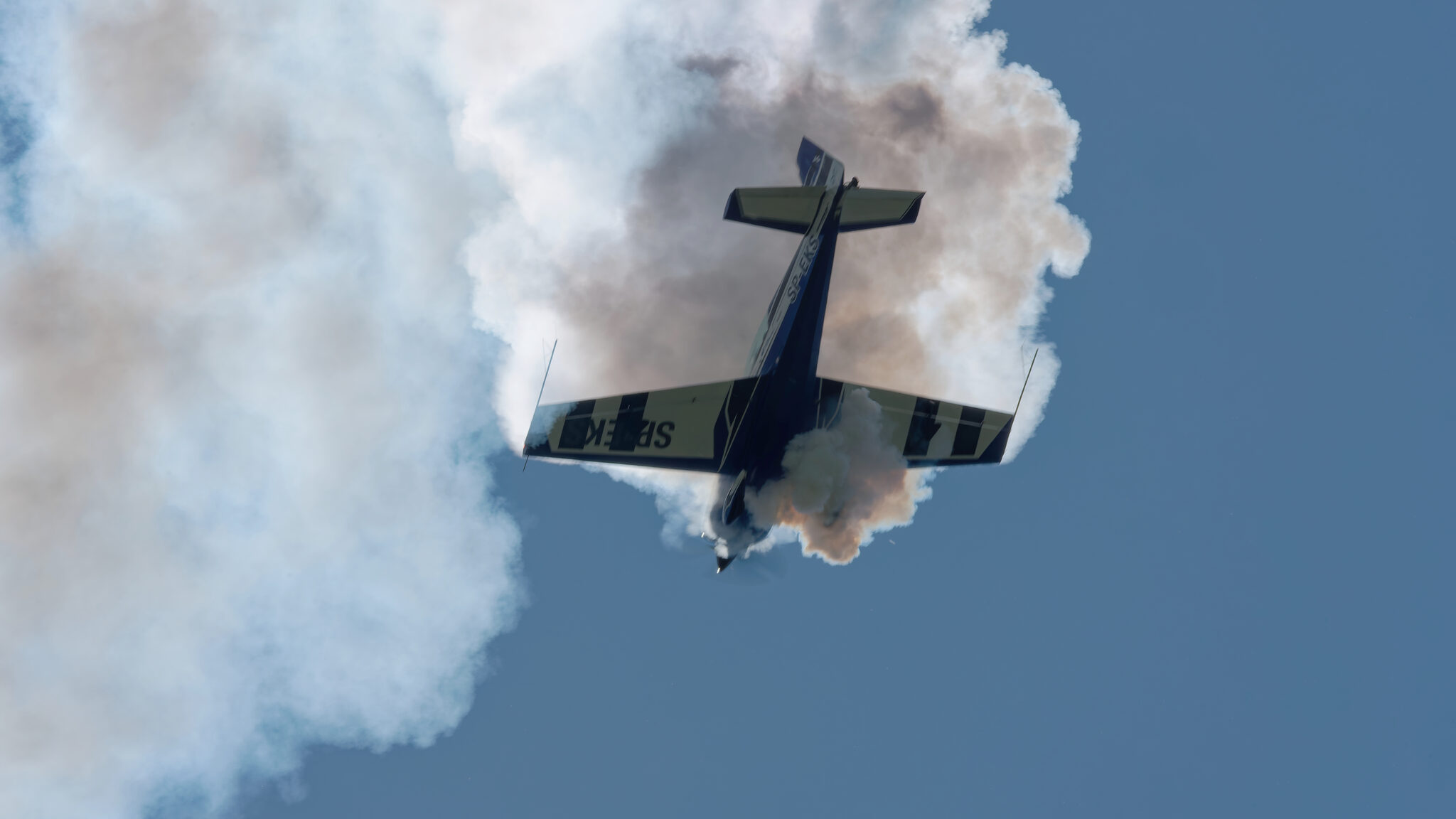 SP-EKS silhouette in dark smoke during a tailslide